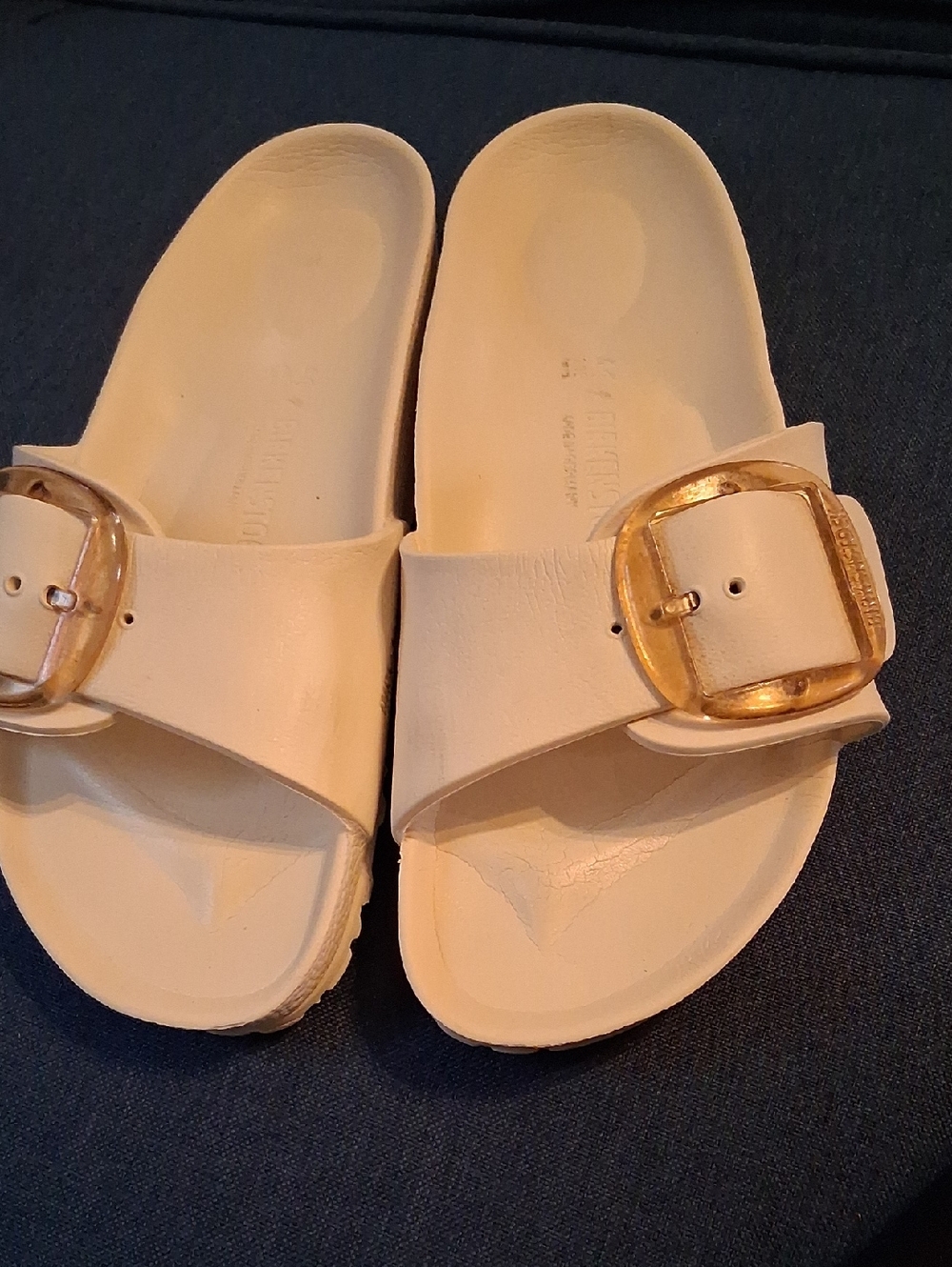 Birkenstock Cream Single-Strap Slide with Gold Buckle Accent